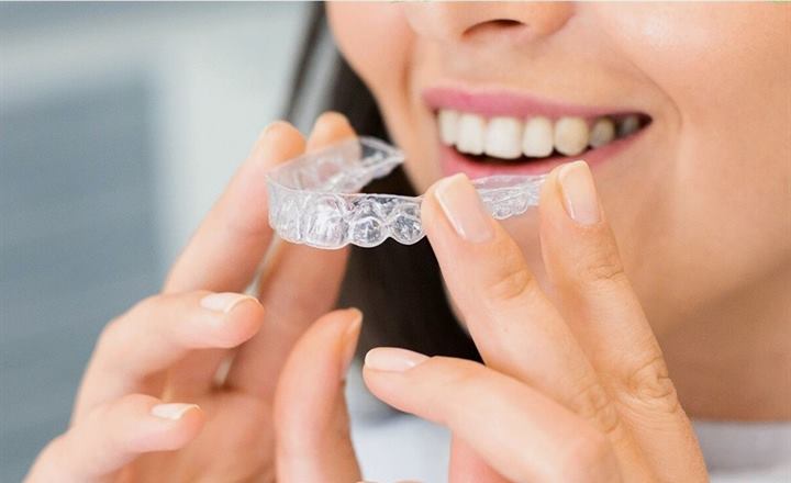 Patient holding a clear aligner